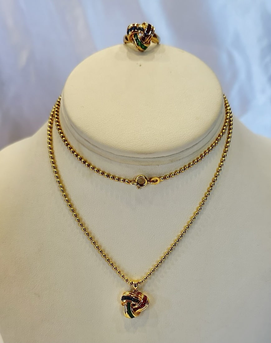 Italian 14K Gold Ruby Emerald Sapphire Ring Necklace Set 5.5: Italian 14K Gold Ruby Emerald Sapphire Ring Necklace Set 5.5 This stunning Italian 14K yellow gold set features a ring and necklace adorned with captivating ruby, emerald, and sapphire gemstones. The 