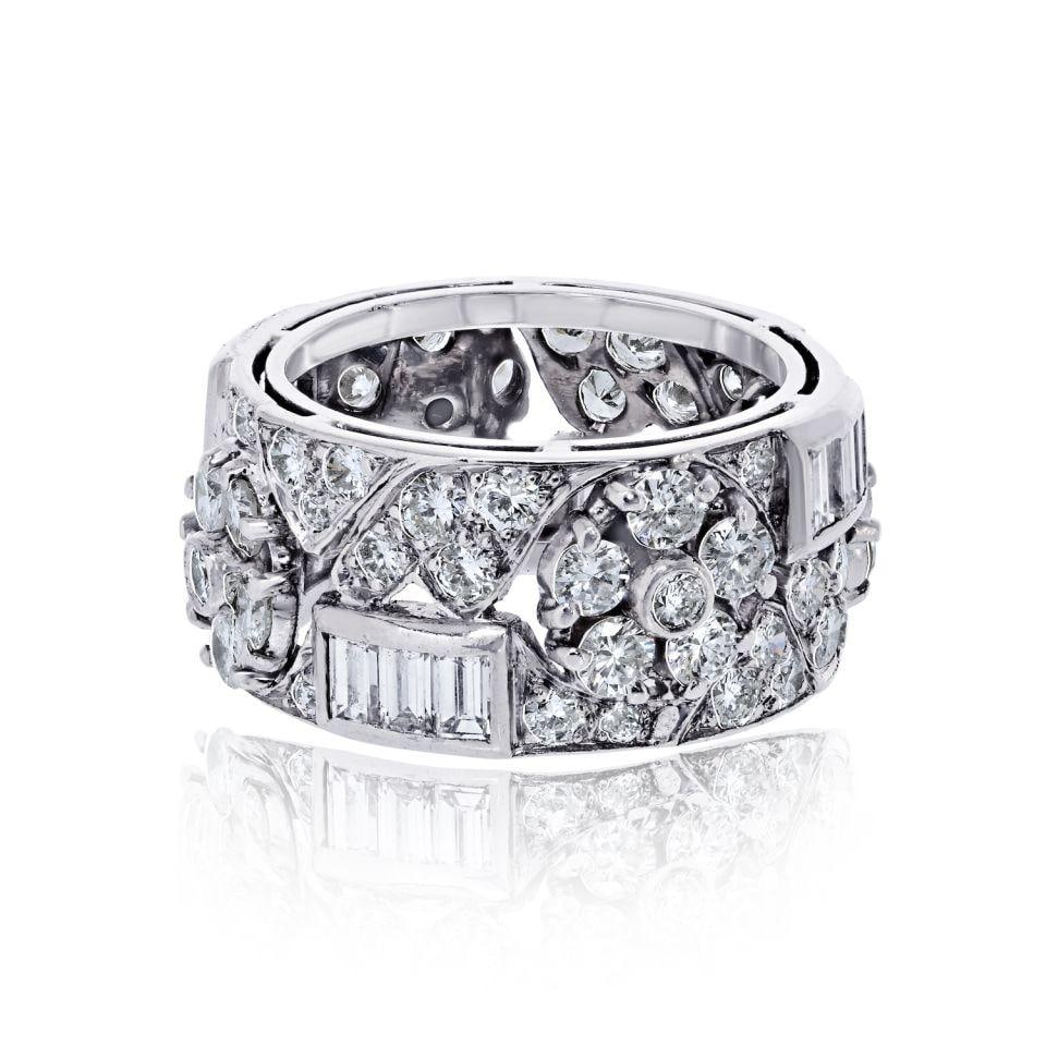 Estate Platinum Floral Motif Ring with 5.50 Ctw Round and Baguette Diamonds: Estate Platinum Floral Motif Ring with 5.50 Ctw Round and Baguette Diamonds Estate ring featuring a floral motif set with baguette and round cut diamonds. This pre-owned piece offers a substantial dia