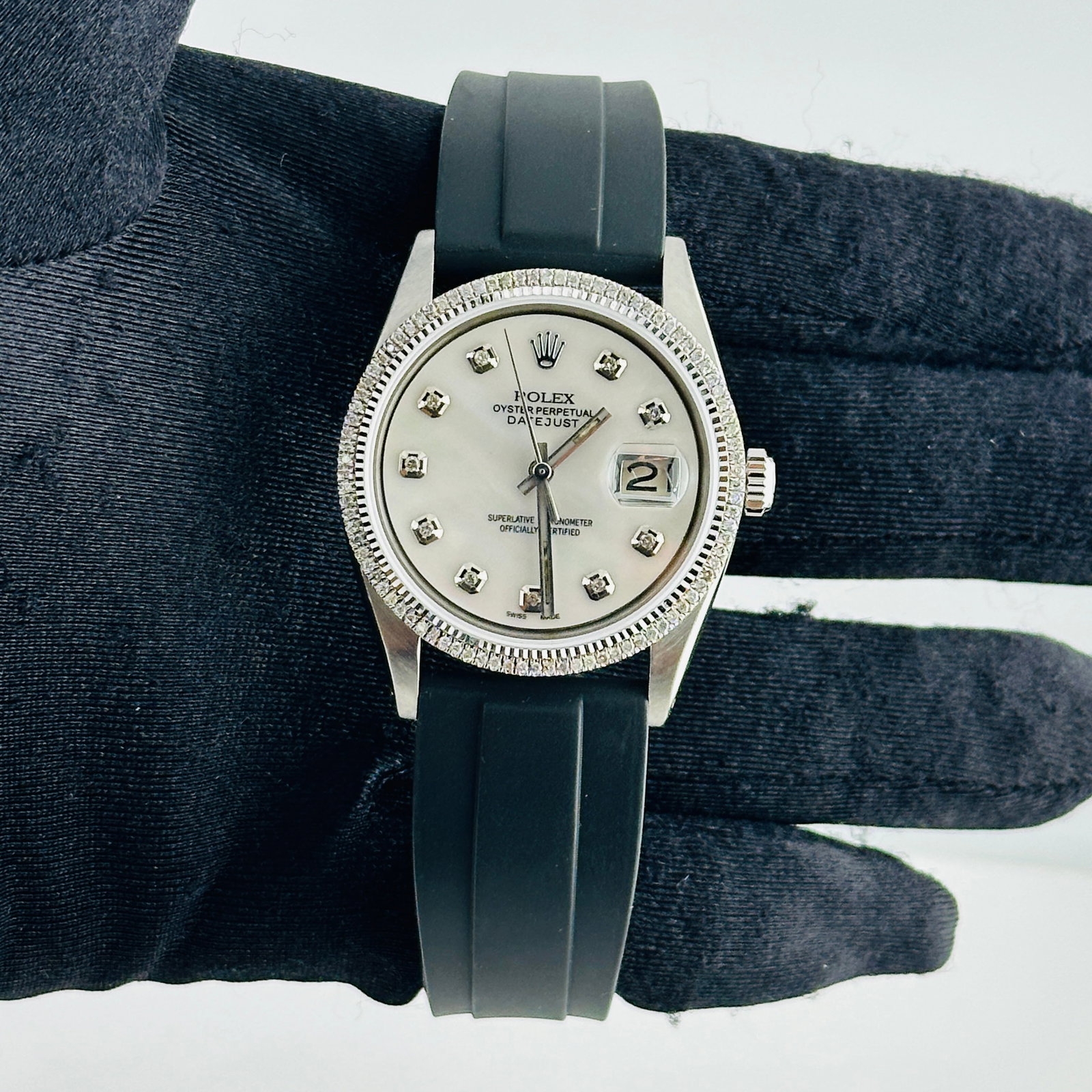 Rolex Datejust 1601 Mens Watch With Aftermarket Mop Diamond Dial Rubber Strap: Rolex Datejust 1601 Mens Watch With Aftermarket Mop Diamond Dial Rubber Strap This Rolex Datejust men's watch features an aftermarket white mother-of-pearl diamond dial and a prong diamond bezel. It i