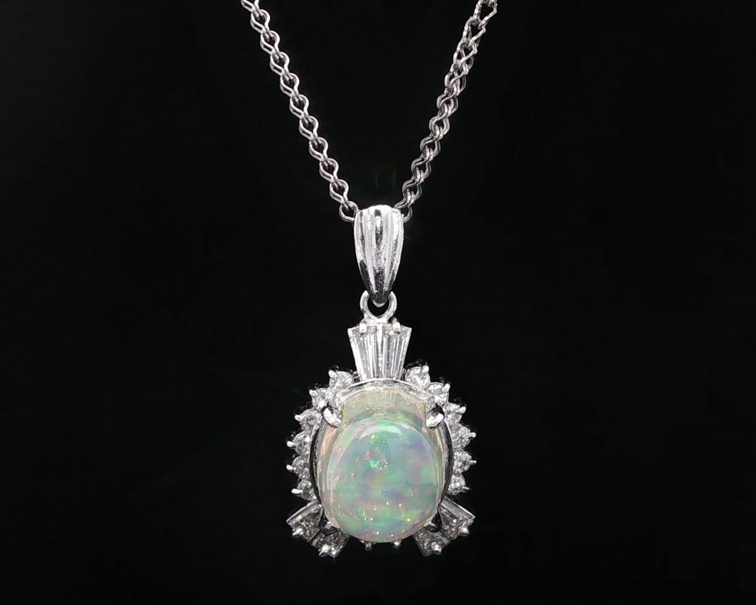 Platinum 7.10ctw Oval Jelly Opal Diamond Border Pendant Necklace: Platinum 7.10ctw Oval Jelly Opal Diamond Border Pendant Necklace This exquisite pendant necklace features a stunning 7.10ctw oval colorful jelly opal, elegantly framed by a unique diamond border. The 