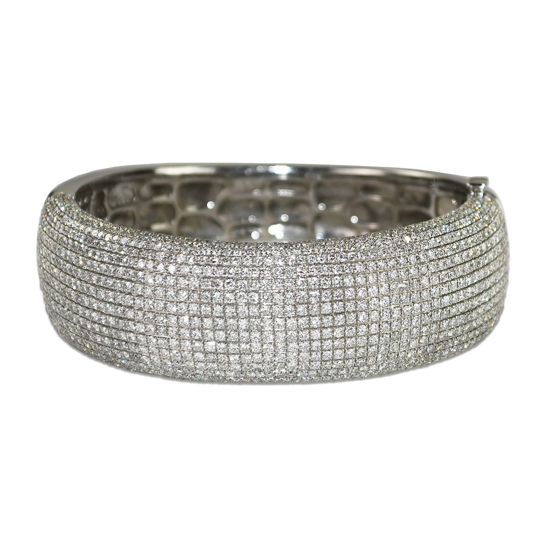 18K White Gold Diamond Bangle 11.20 Carats Clip-On Closure: 18K White Gold Diamond Bangle 11.20 Carats Clip-On Closure This ladies' bangle bracelet is crafted from 18k white gold and features a cluster setting of round brilliant natural diamonds. The diamonds 