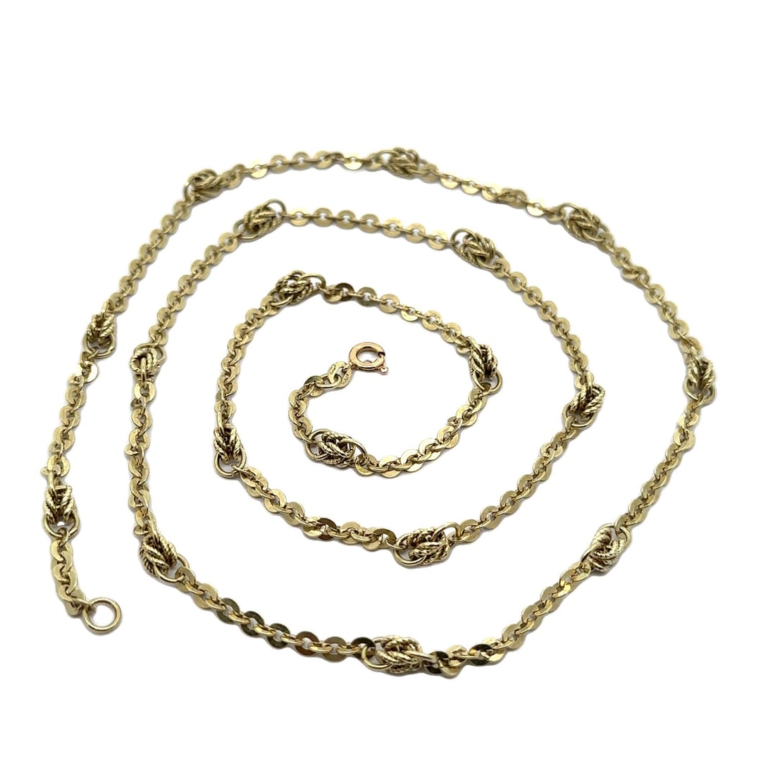 30 Inch 14k Yellow Gold Flat Cable Link Chain Necklace With Knot Accents Italy: 30 Inch 14k Yellow Gold Flat Cable Link Chain Necklace With Knot Accents Italy This Italian necklace features a 30-inch flat cable link chain crafted from solid 14k yellow gold. The design is enhanced