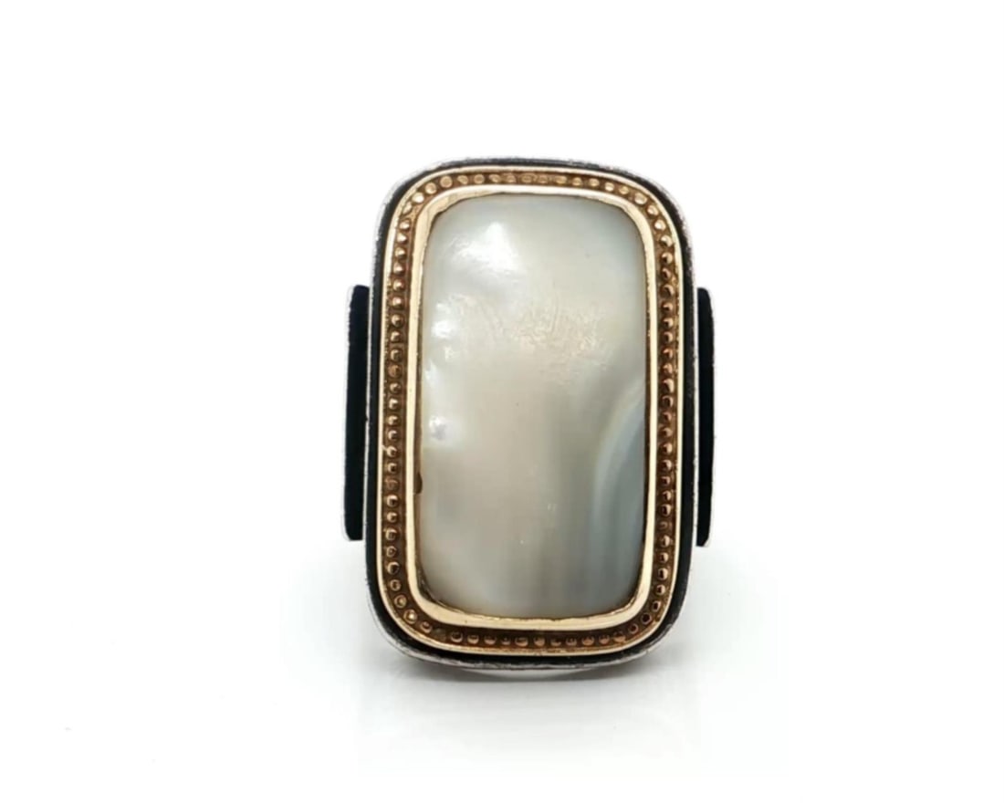 Konstantino statement ring in sterling silver and 18k gold with mother of pearl: Konstantino statement ring in sterling silver and 18k gold with mother of pearl Authentic Konstantino statement ring featuring a natural mother-of-pearl center set in sterling silver with 18k yellow g