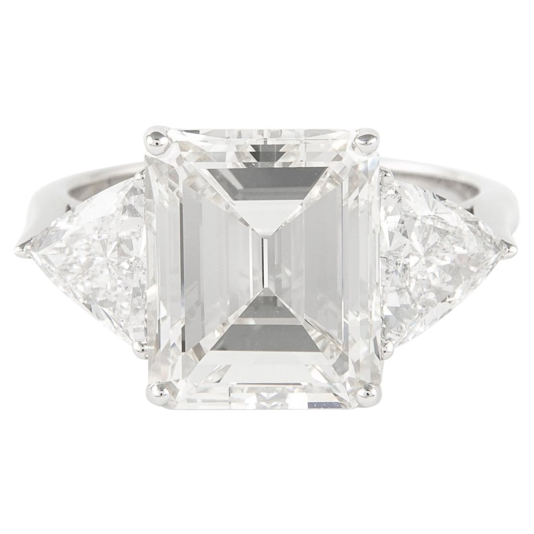 18k White Gold 3 Stone Ring 5.20ct Emerald Cut Diamond GIA: 18k White Gold 3 Stone Ring 5.20ct Emerald Cut Diamond GIA This exquisite three-stone engagement ring features a stunning 5.20 carat emerald cut diamond at its center. The diamond is GIA certified wit