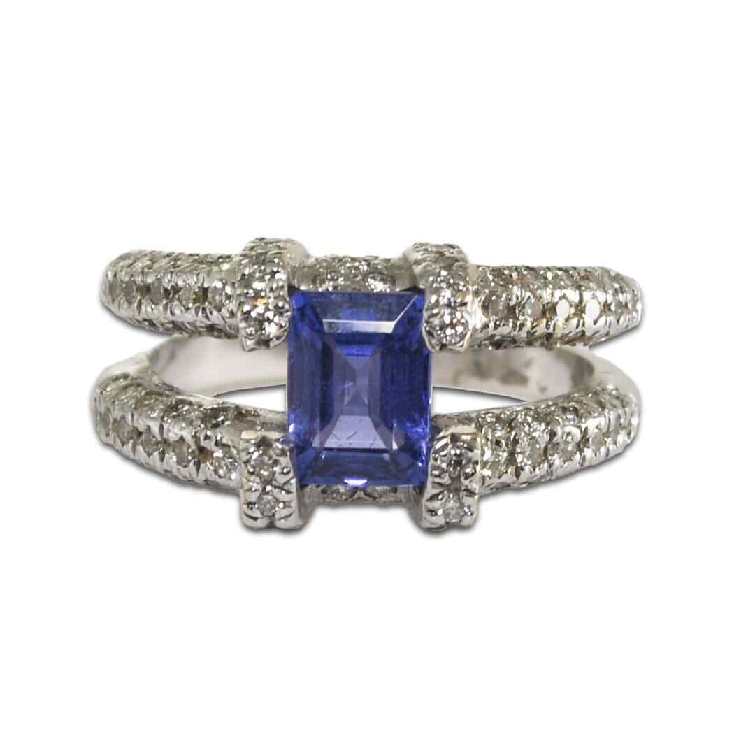Unbranded 18K White Gold Ring with Tanzanite and Diamonds: Unbranded 18K White Gold Ring with Tanzanite and Diamonds Pre-owned ladies' tanzanite and diamond band ring in 18k white gold. It features a rectangular tanzanite center stone accented by round brilli
