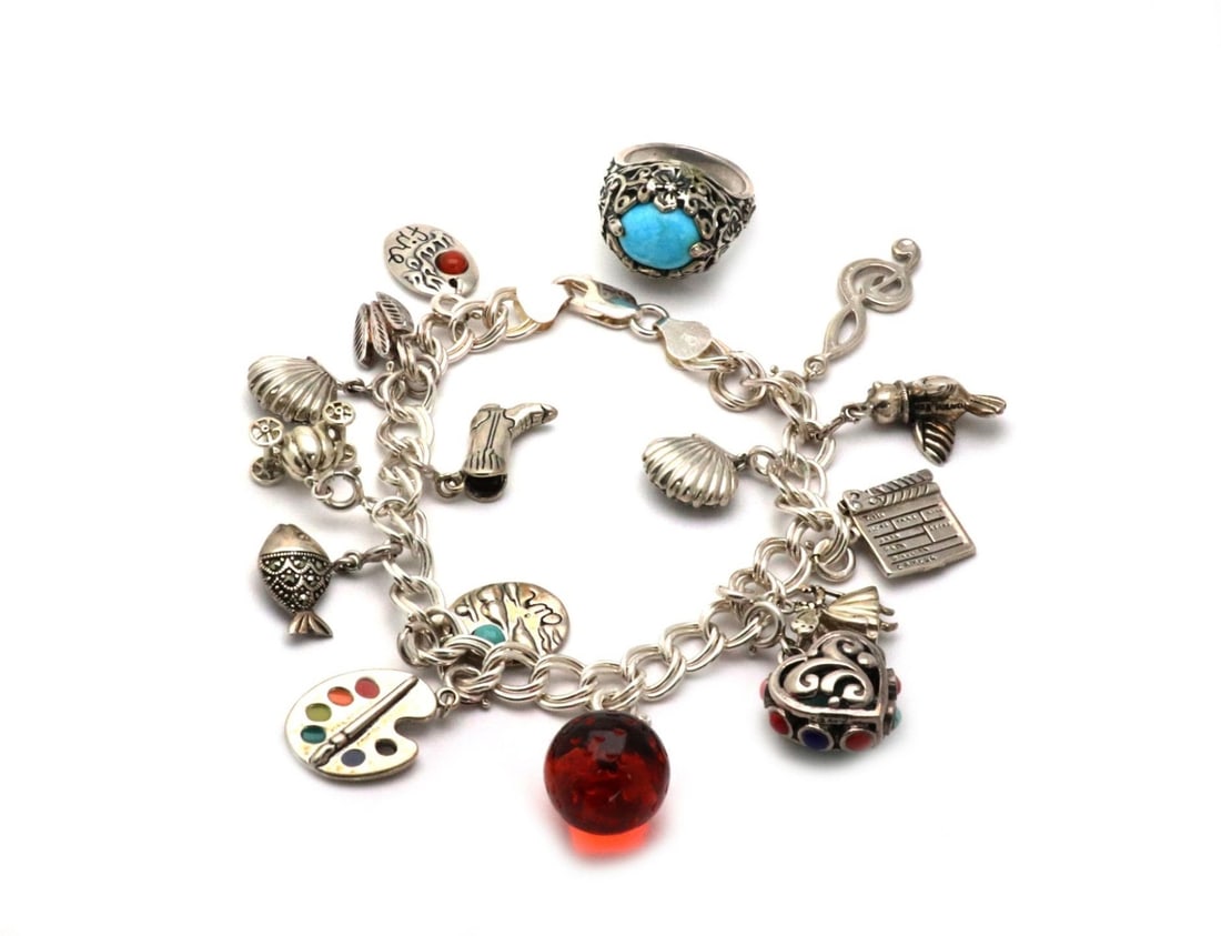 Sterling Silver Multi Charm Bracelet and Ring Set with Turquoise and Marcasite: Sterling Silver Multi Charm Bracelet and Ring Set with Turquoise and Marcasite This stunning jewelry set features a multi-charm bracelet and a ring, both crafted from high-quality sterling silver. The