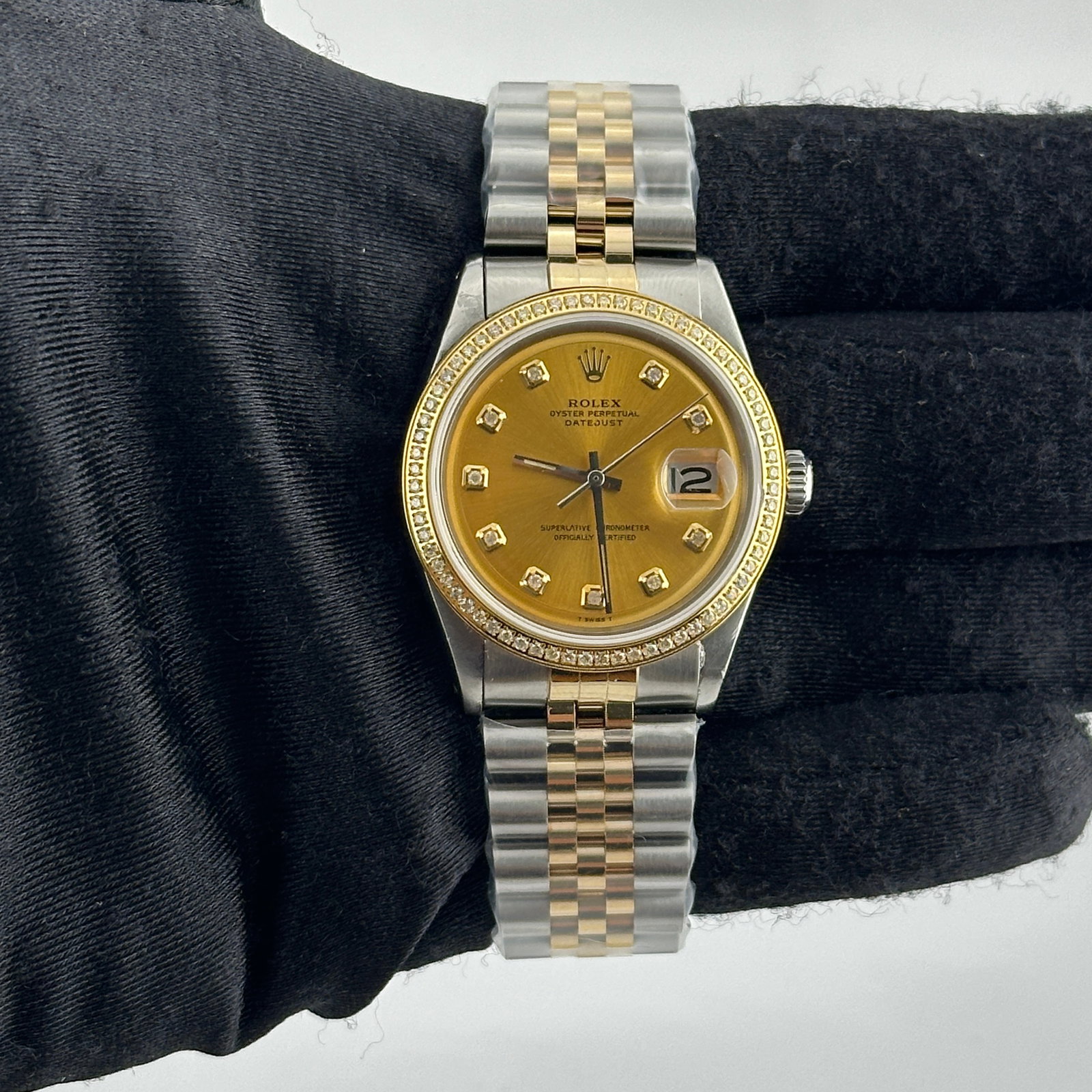 Mens Rolex Datejust 1601 Aftermarket Champagne Diamond Dial Jubilee Bracelet: Mens Rolex Datejust 1601 Aftermarket Champagne Diamond Dial Jubilee Bracelet This men's Rolex Datejust features an aftermarket champagne diamond dial and a pave-plated diamond bezel. The watch is iden