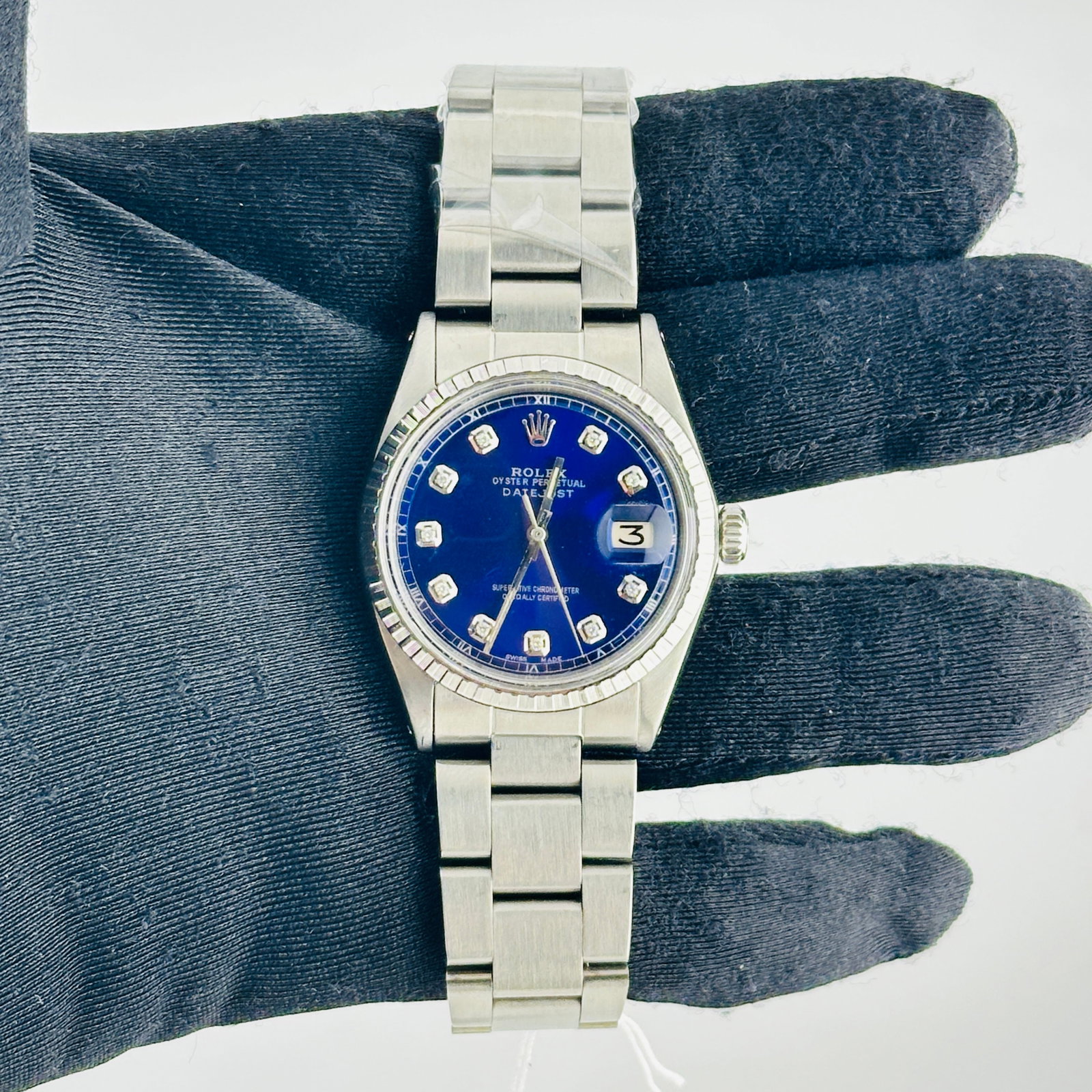 Rolex Datejust Ref 1603 mens watch aftermarket blue diamond dial Oyster bracelet: Rolex Datejust Ref 1603 mens watch aftermarket blue diamond dial Oyster bracelet This is a men's Rolex Datejust watch, reference number 1603. It features an aftermarket white mother-of-pearl diamond d