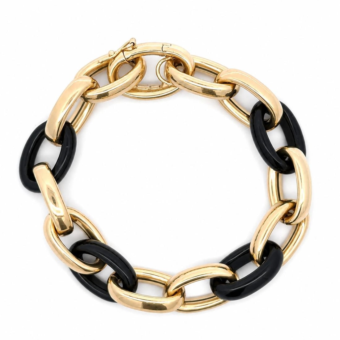 Unbranded 18k Yellow Gold Bracelet with 4 Black Onyx Oval Links: Unbranded 18k Yellow Gold Bracelet with 4 Black Onyx Oval Links Vintage chain bracelet crafted in solid 18k yellow gold with open oval black onyx links in a puffed Italian design. This pre-owned brace