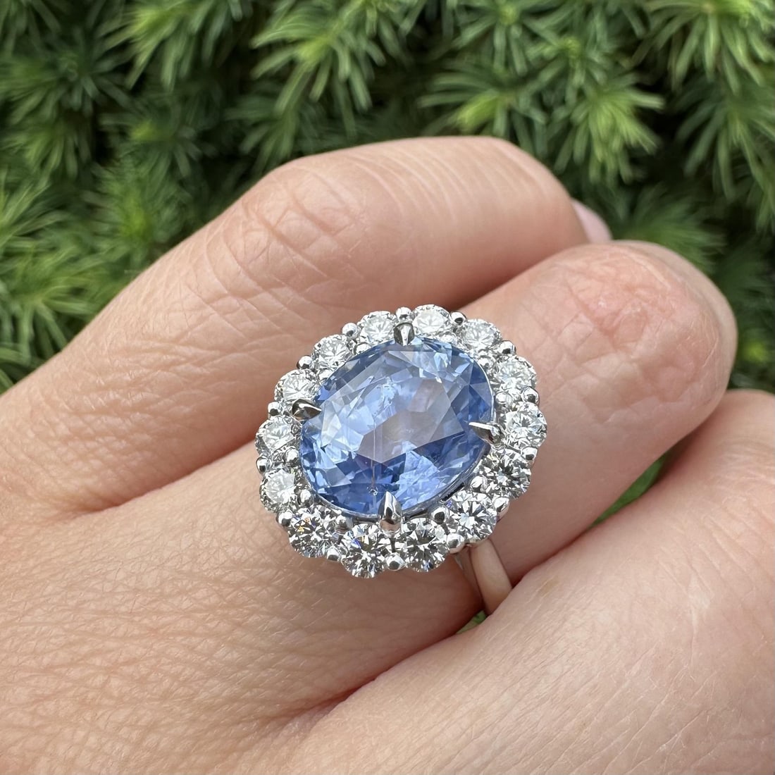 GIA Ceylon Sapphire Platinum Halo Ring with 14 Diamonds: GIA Ceylon Sapphire Platinum Halo Ring with 14 Diamonds This platinum cocktail ring features an impressive 7.09 carat natural Ceylon sapphire, certified by GIA as unheated and displaying a vibrant cor