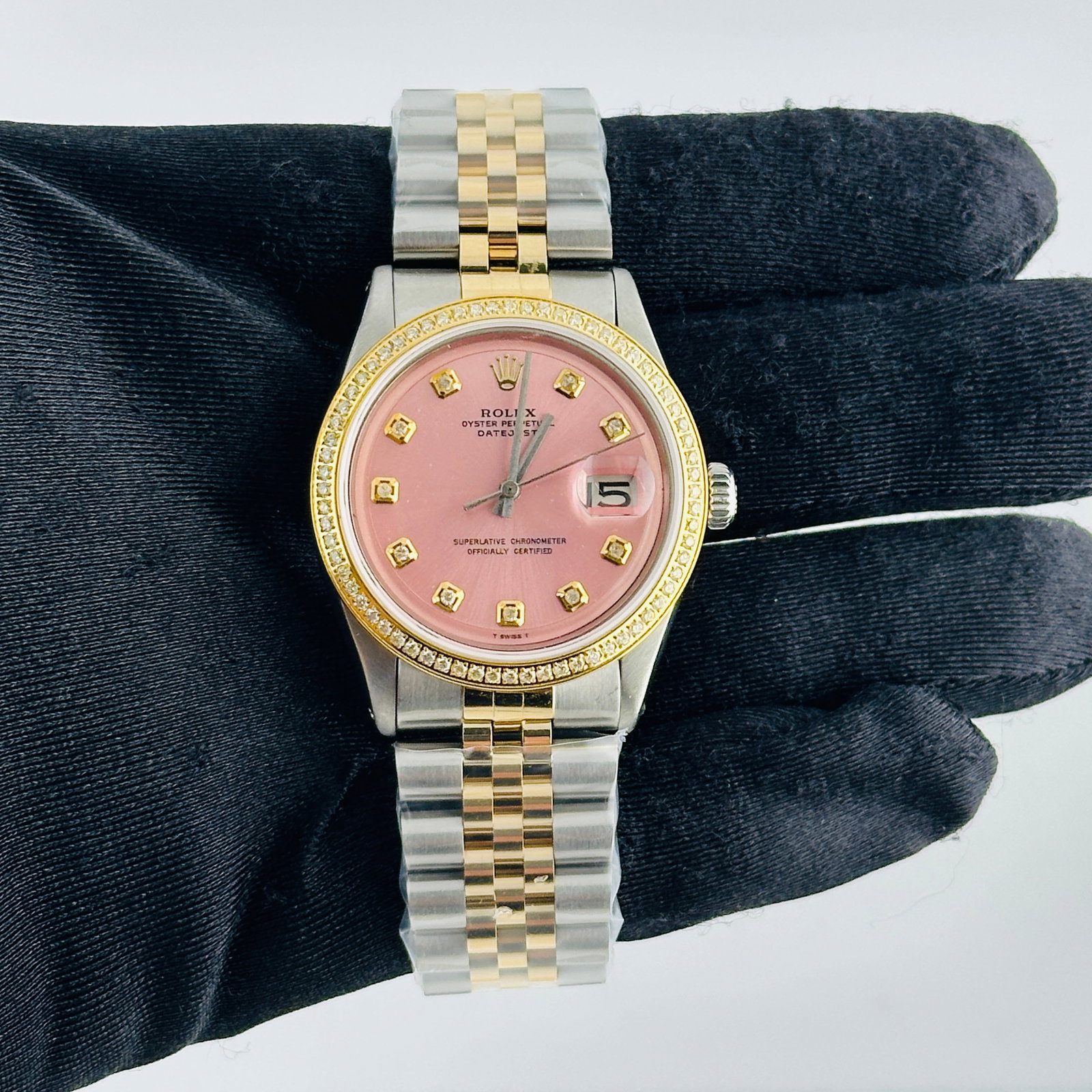 Rolex Datejust 1601 Pink Yellow Diamond Dial Aftermarket Jubilee Bracelet: Rolex Datejust 1601 Pink Yellow Diamond Dial Aftermarket Jubilee Bracelet This men's Rolex Datejust features an aftermarket pink dial with yellow diamond hour markers, complemented by an aftermarket J