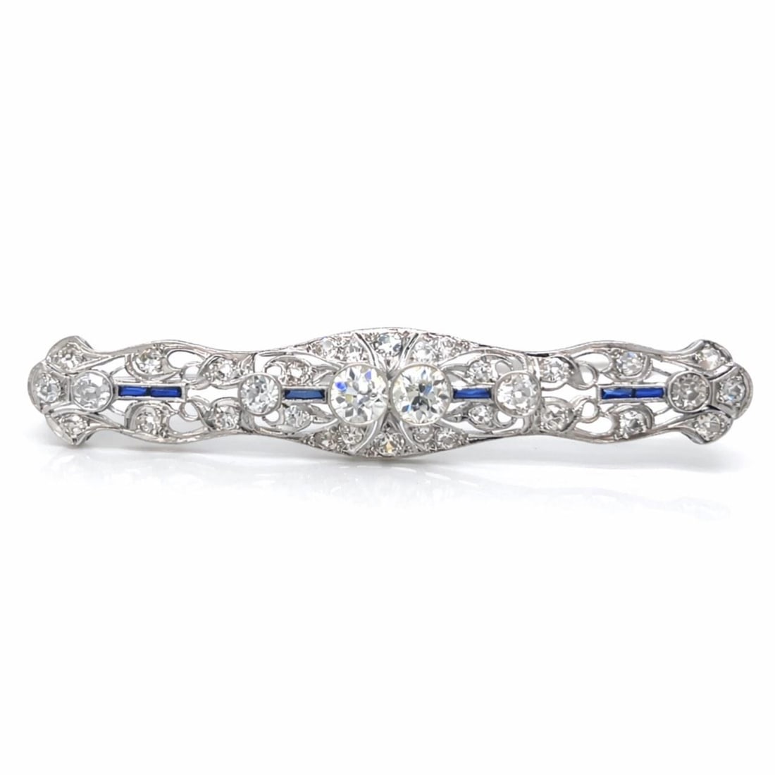 Platinum Art Deco Brooch with 3.50 Carat Diamonds and Sapphires: Platinum Art Deco Brooch with 3.50 Carat Diamonds and Sapphires This Art Deco brooch is crafted in platinum and features approximately 3.50 carats of diamonds and sapphires. The design includes two di