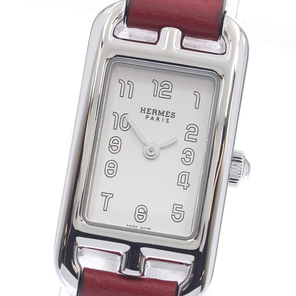 Hermes Nantucket NA2.110 womens quartz stainless steel wristwatch: Hermes Nantucket NA2.110 womens quartz stainless steel wristwatch This pre-owned Hermes Nantucket women's wristwatch features a stainless steel case, silver dial, and leather belt. It is powered by a 