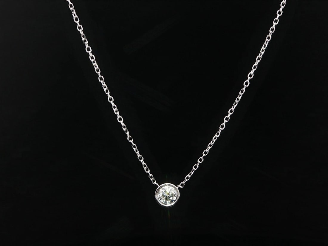 0.20ct Bezel Set Diamond Pendant on 14k White Gold Chain Necklace: 0.20ct Bezel Set Diamond Pendant on 14k White Gold Chain Necklace This un-used pendant necklace features a natural round brilliant diamond weighing 0.20 carats, bezel set in solid 14k white gold. The 