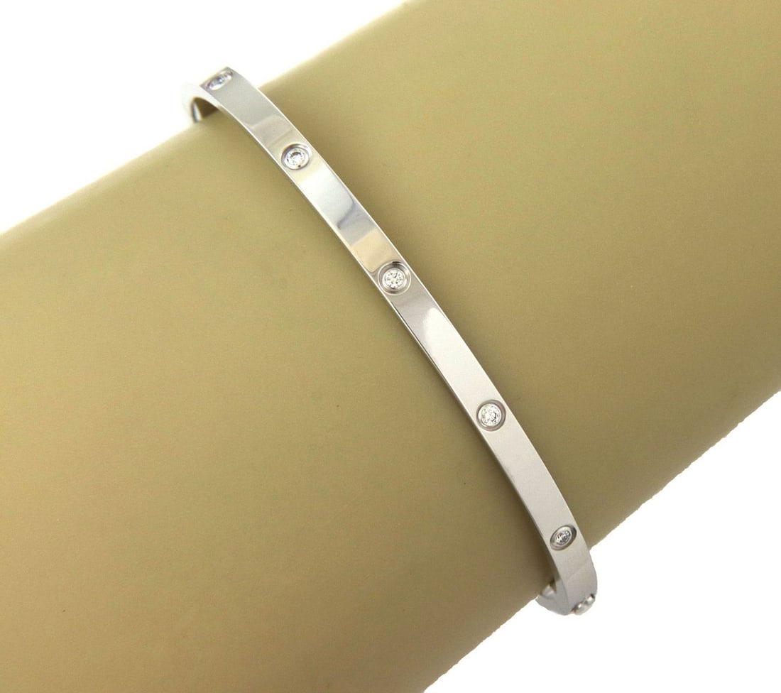 Cartier Love Small Model 18k White Gold Diamond Bangle Size 18 with Papers: Cartier Love Small Model 18k White Gold Diamond Bangle Size 18 with Papers Authentic Cartier Love Collection small model bangle crafted in 18k white gold with a high polished finish and oval form. The