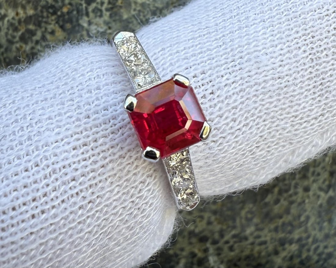 Platinum Solitaire Ring with GIA Certified Burma Ruby and Diamond Accents: Platinum Solitaire Ring with GIA Certified Burma Ruby and Diamond Accents This vintage platinum ring features a vivid pigeon blood red Burma ruby, certified by GIA, as the centerpiece. The octagonal s