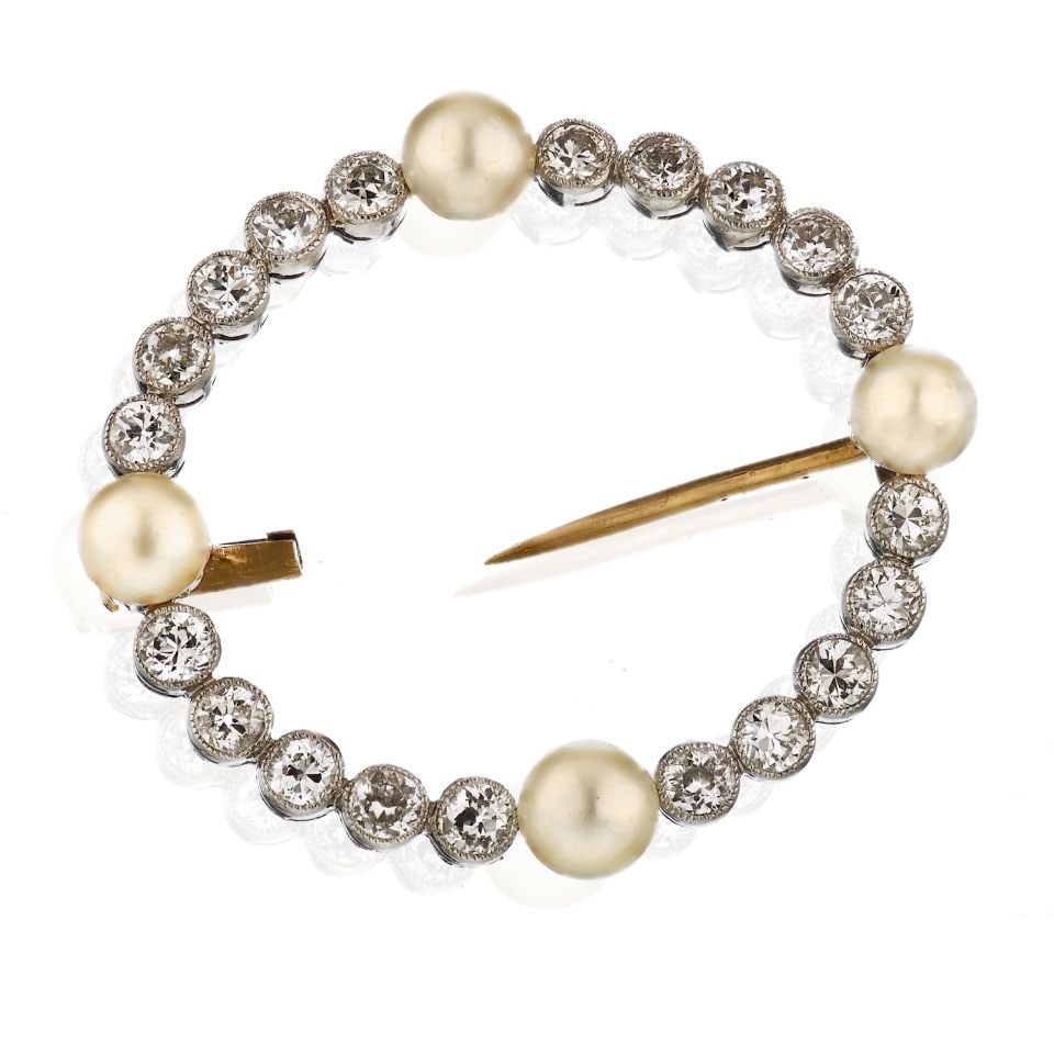 Victorian Platinum and 14K Gold Brooch with 20 Diamonds and 4 Pearls: Victorian Platinum and 14K Gold Brooch with 20 Diamonds and 4 Pearls This exquisite Victorian brooch features a stunning open circle design, elegantly crafted in platinum and accented with 14K yellow 