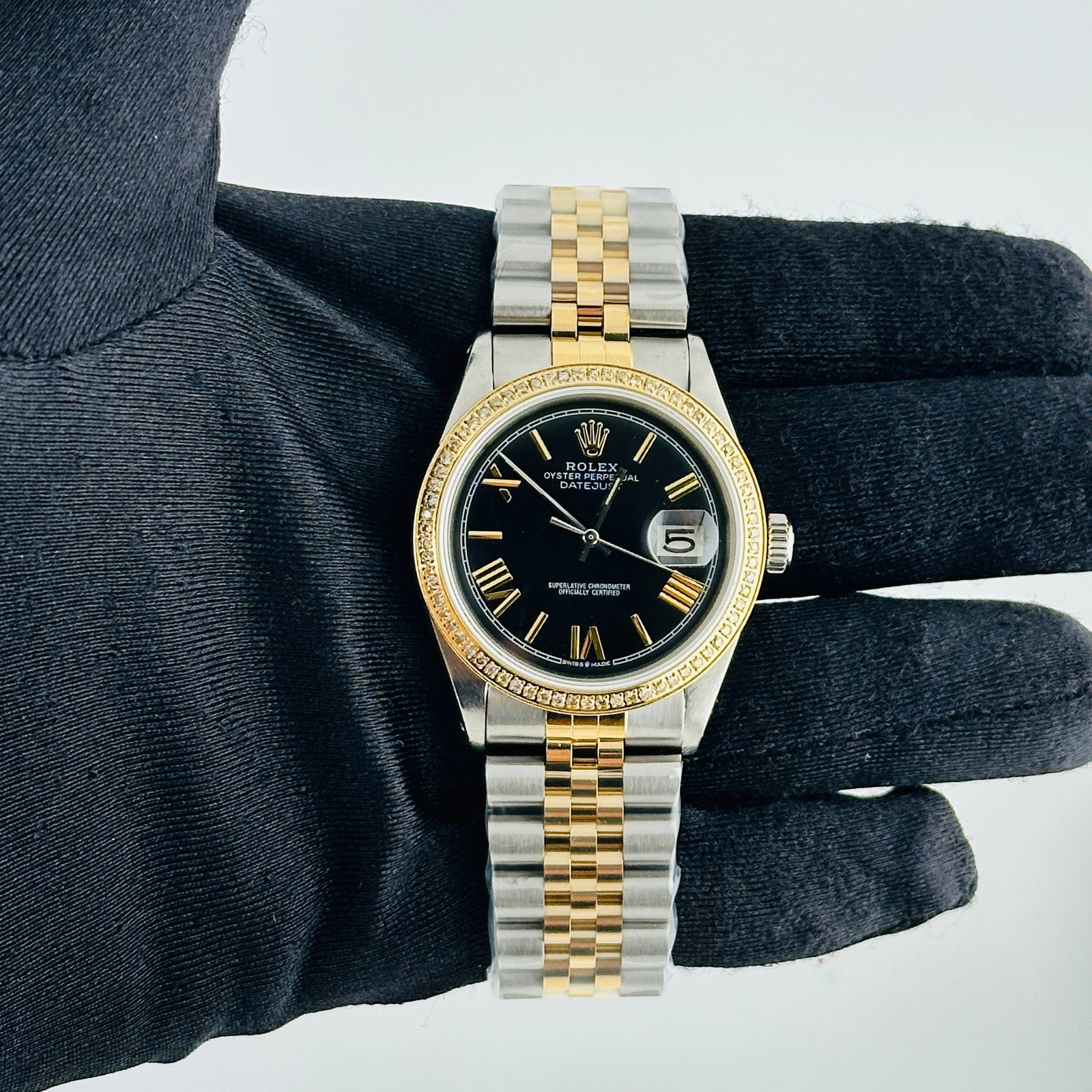 Rolex Datejust Ref 1601 Watch With Aftermarket Black Roman Dial and Jubilee Bracelet: Rolex Datejust Ref 1601 Watch With Aftermarket Black Roman Dial and Jubilee Bracelet This men's Rolex Datejust features an aftermarket black dial with Roman numeral stick markers and is set on an afte
