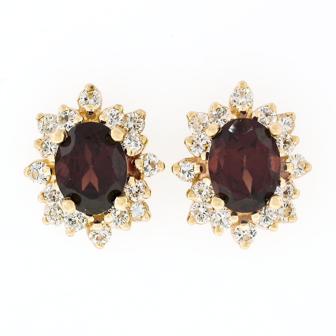 Unbranded 14k Yellow Gold Garnet Diamond Halo Stud Earrings 3.80ctw: Unbranded 14k Yellow Gold Garnet Diamond Halo Stud Earrings 3.80ctw Elegant stud earrings crafted in solid 14k yellow gold, featuring natural oval garnets surrounded by a layered halo of round brillia