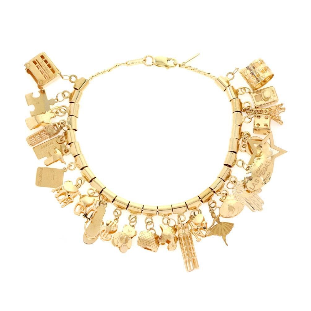 26 Charm 14k Yellow Gold Woven Link Bracelet 7.25 in: 26 Charm 14k Yellow Gold Woven Link Bracelet 7.25 in This exquisite multi-charms bracelet is crafted from 14k yellow gold and features an array of assorted size and shape charms that dangle elegantly 