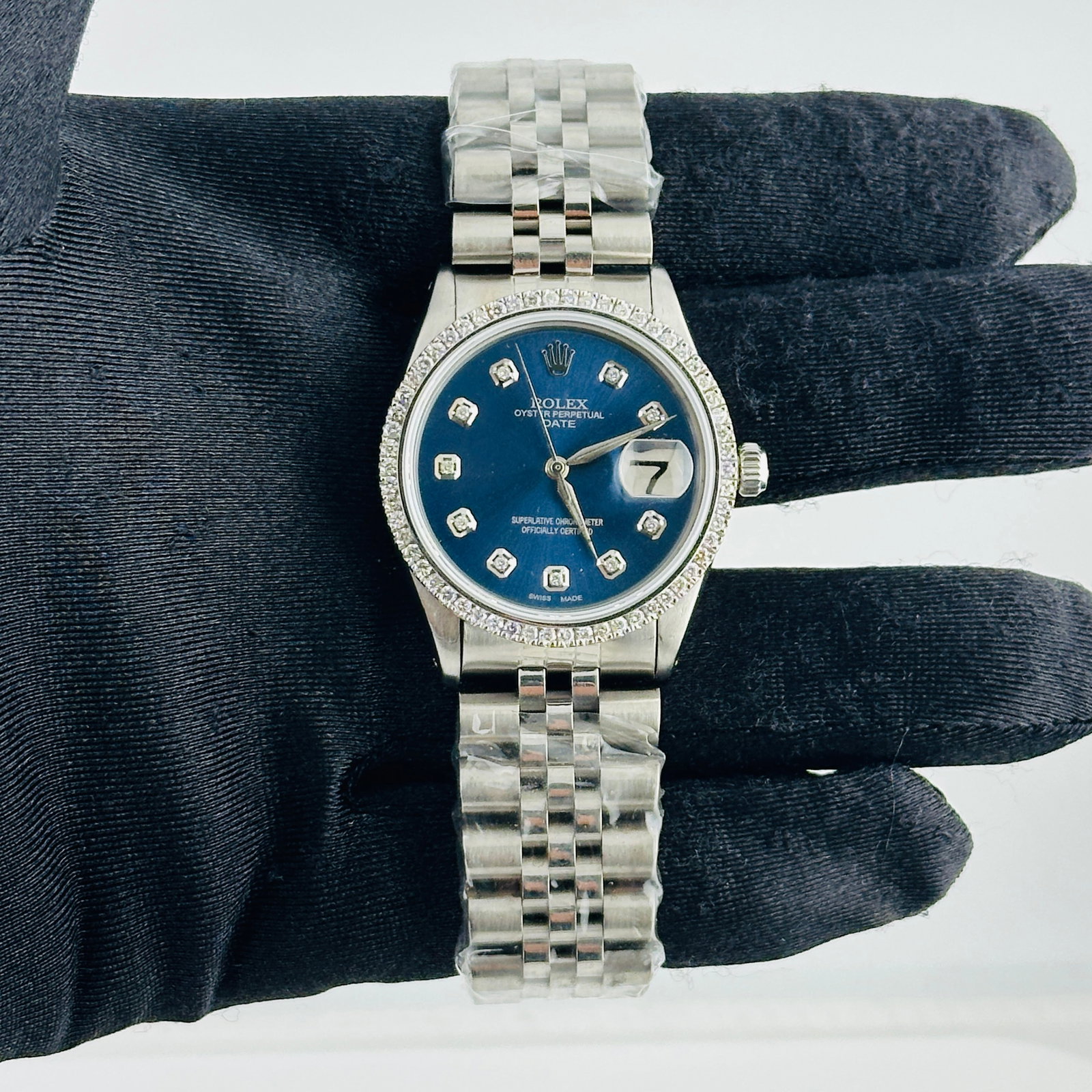 Rolex Date aftermarket blue diamond dial Jubilee bracelet Ref 6694: Rolex Date aftermarket blue diamond dial Jubilee bracelet Ref 6694 This Rolex Date watch, reference 6694, features an aftermarket blue diamond dial and a prong-set diamond bezel. It is paired with an 