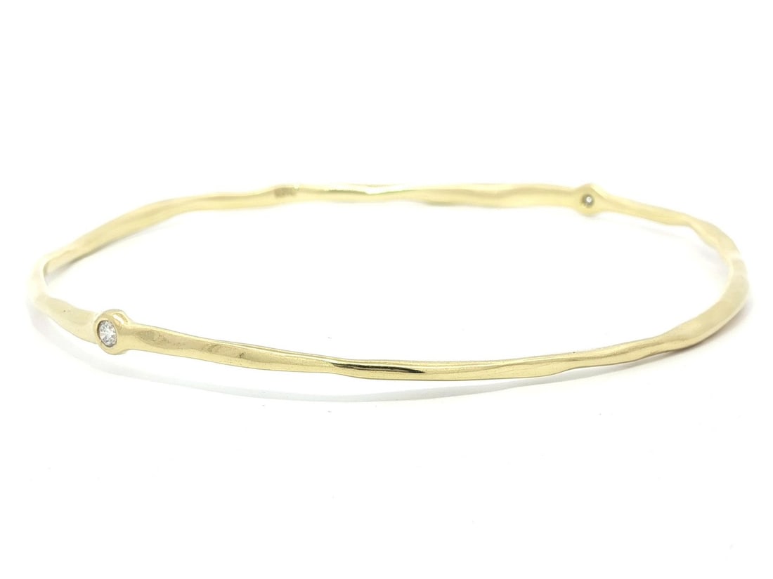 Slip On 18k Yellow Gold Bangle With 0.10ctw Round Bezel Set Diamonds: Slip On 18k Yellow Gold Bangle With 0.10ctw Round Bezel Set Diamonds This pre-owned slip-on bangle bracelet is crafted from solid 18k yellow gold and set with two natural round brilliant-cut diamonds 