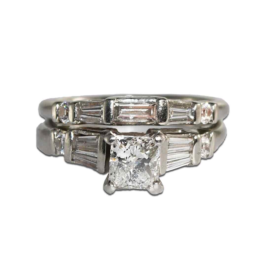 Princess Cut Diamond Platinum Bridal Set Size 5 AIG Graded: Princess Cut Diamond Platinum Bridal Set Size 5 AIG Graded This platinum engagement and wedding ring set features a princess cut diamond as the centerpiece, accompanied by a matching diamond band. The