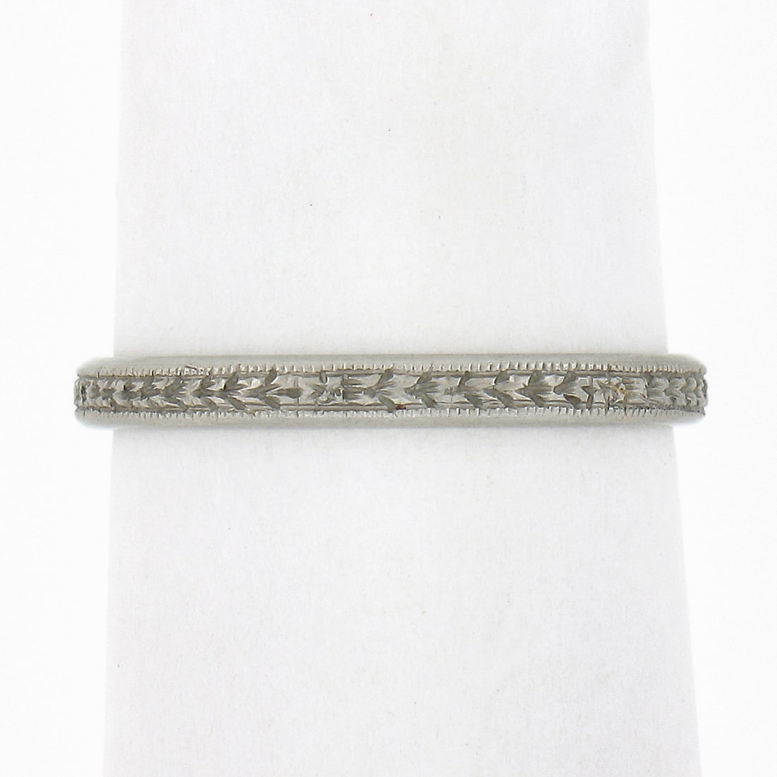 Antique 18k White Gold Wheat Stack Band Ring with Milgrain Details: Antique 18k White Gold Wheat Stack Band Ring with Milgrain Details This exquisite antique stack band ring is crafted from solid 18k white gold, showcasing detailed wheat work with milgrain sides. Its 