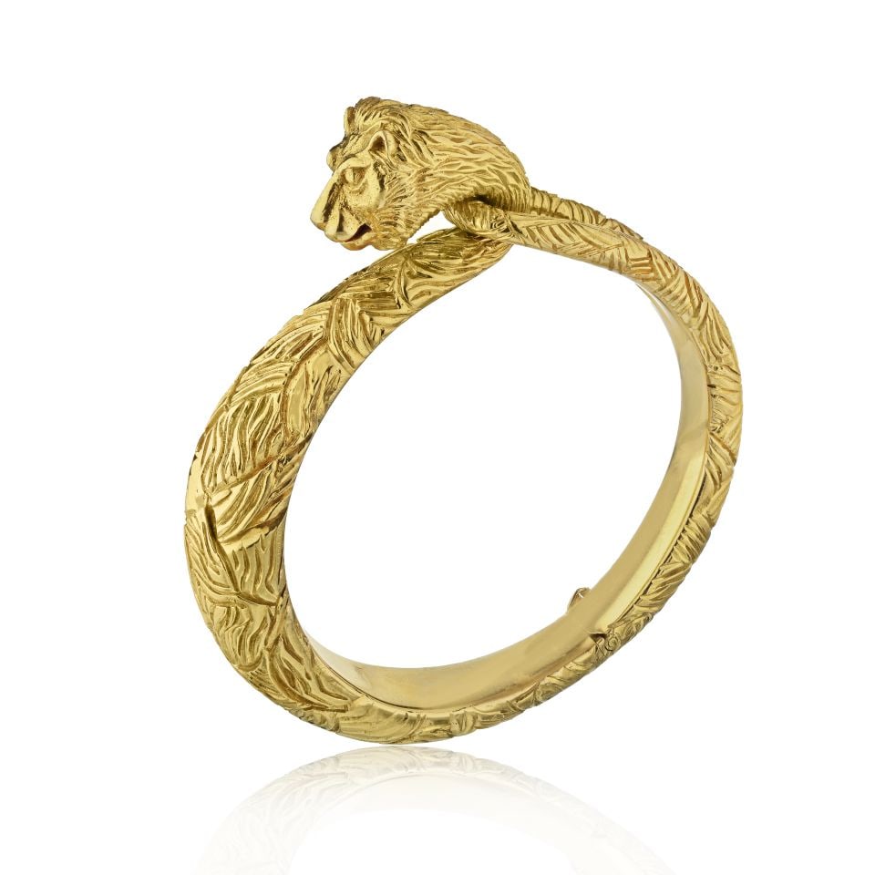 Cartier Vintage 18K Yellow Gold Lion Bangle Bracelet: Cartier Vintage 18K Yellow Gold Lion Bangle Bracelet This exquisite vintage Cartier bangle bracelet features a striking carved lion design, crafted from luxurious 18K yellow gold. With a weight of 99.