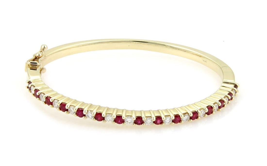Vintage 14k Yellow Gold Oval Bangle Bracelet with Ruby and Diamond Accents: Vintage 14k Yellow Gold Oval Bangle Bracelet with Ruby and Diamond Accents Vintage oval hinged bangle bracelet crafted in solid 14k yellow gold, featuring natural diamonds and natural rubies in a clas