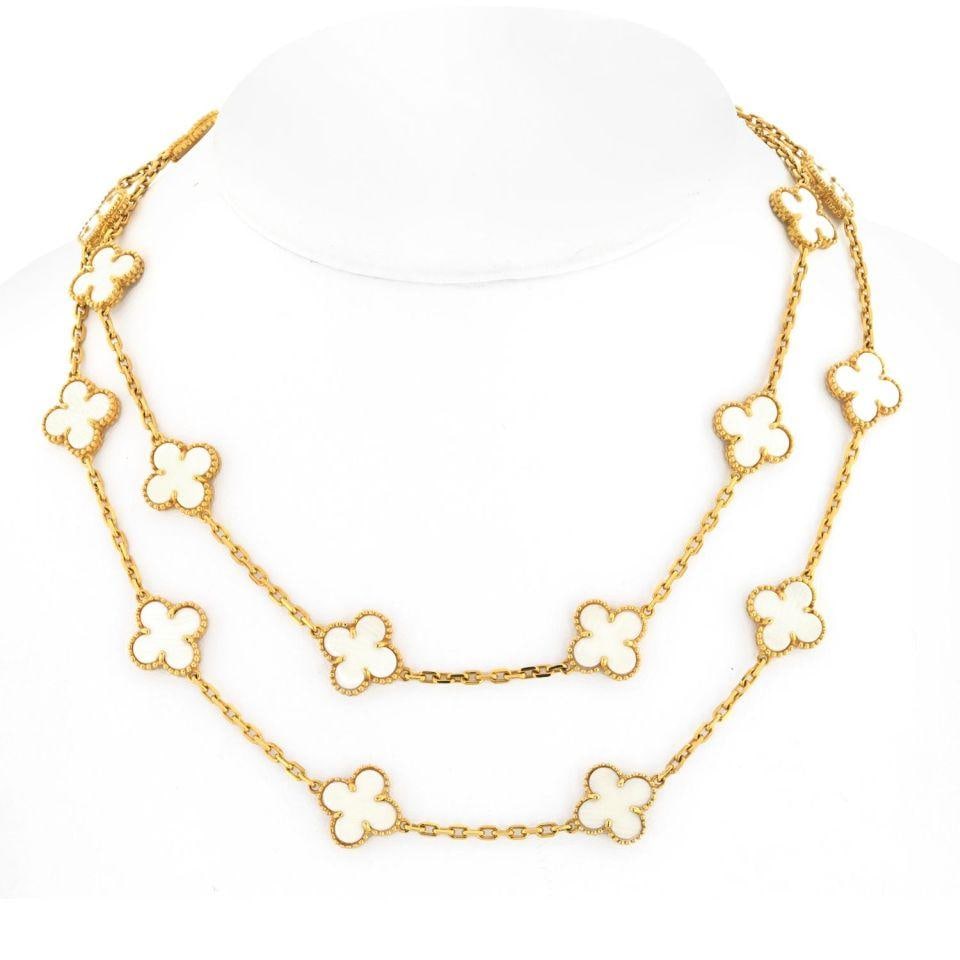 Alhambra White Coral 20 Motif Necklace in 18K Yellow Gold Circa 1985: Alhambra White Coral 20 Motif Necklace in 18K Yellow Gold Circa 1985 This Van Cleef & Arpels Alhambra necklace features 20 clover-shaped motifs crafted from 18K yellow gold and white coral, trimmed wi