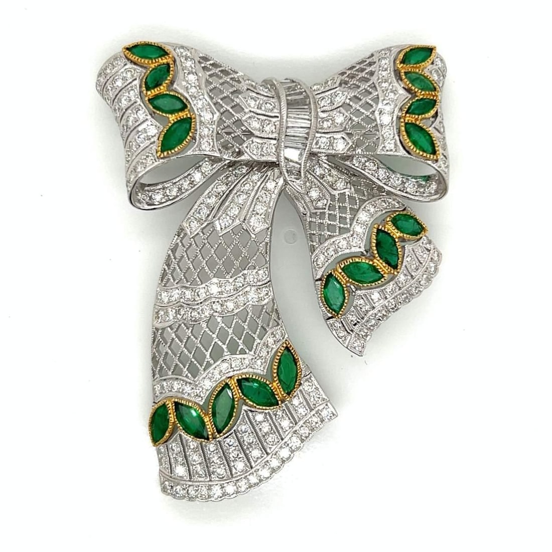 18K White Gold Emerald Diamond Brooch 204 Diamonds 17 Emeralds: 18K White Gold Emerald Diamond Brooch 204 Diamonds 17 Emeralds This stunning 18K white gold brooch features a captivating combination of emeralds and diamonds. The piece weighs 32.7 grams and is adorn