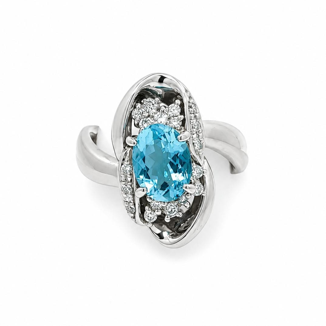Platinum Cocktail Ring with 1.28ctw Aquamarine and Diamond Freeform Design: Platinum Cocktail Ring with 1.28ctw Aquamarine and Diamond Freeform Design Cocktail ring in a long freeform design featuring one natural oval brilliant cut aquamarine in a rich blue color and 18 natur