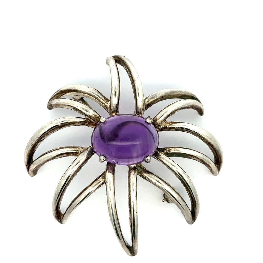 Tiffany & Co. Sterling Silver Amethyst Fireworks Brooch Pin 1995: Tiffany & Co. Sterling Silver Amethyst Fireworks Brooch Pin 1995 This exquisite Tiffany & Co. brooch features a stunning large cabochon amethyst, showcasing a beautiful purple hue. The natural genuine