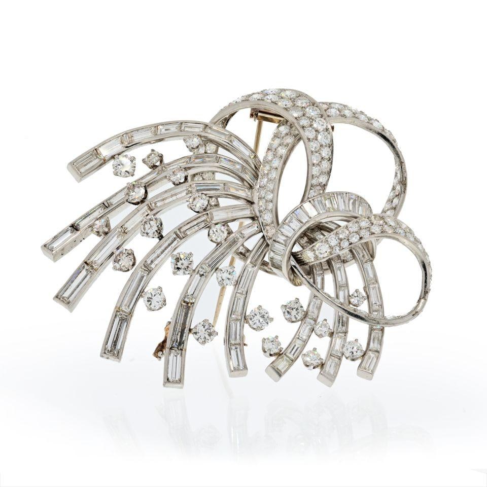 1950's Platinum Brooch with 35 Carats Round and Baguette Diamonds: 1950's Platinum Brooch with 35 Carats Round and Baguette Diamonds This exquisite 1950's brooch is a stunning example of vintage jewelry design, crafted from solid platinum and adorned with an impressi