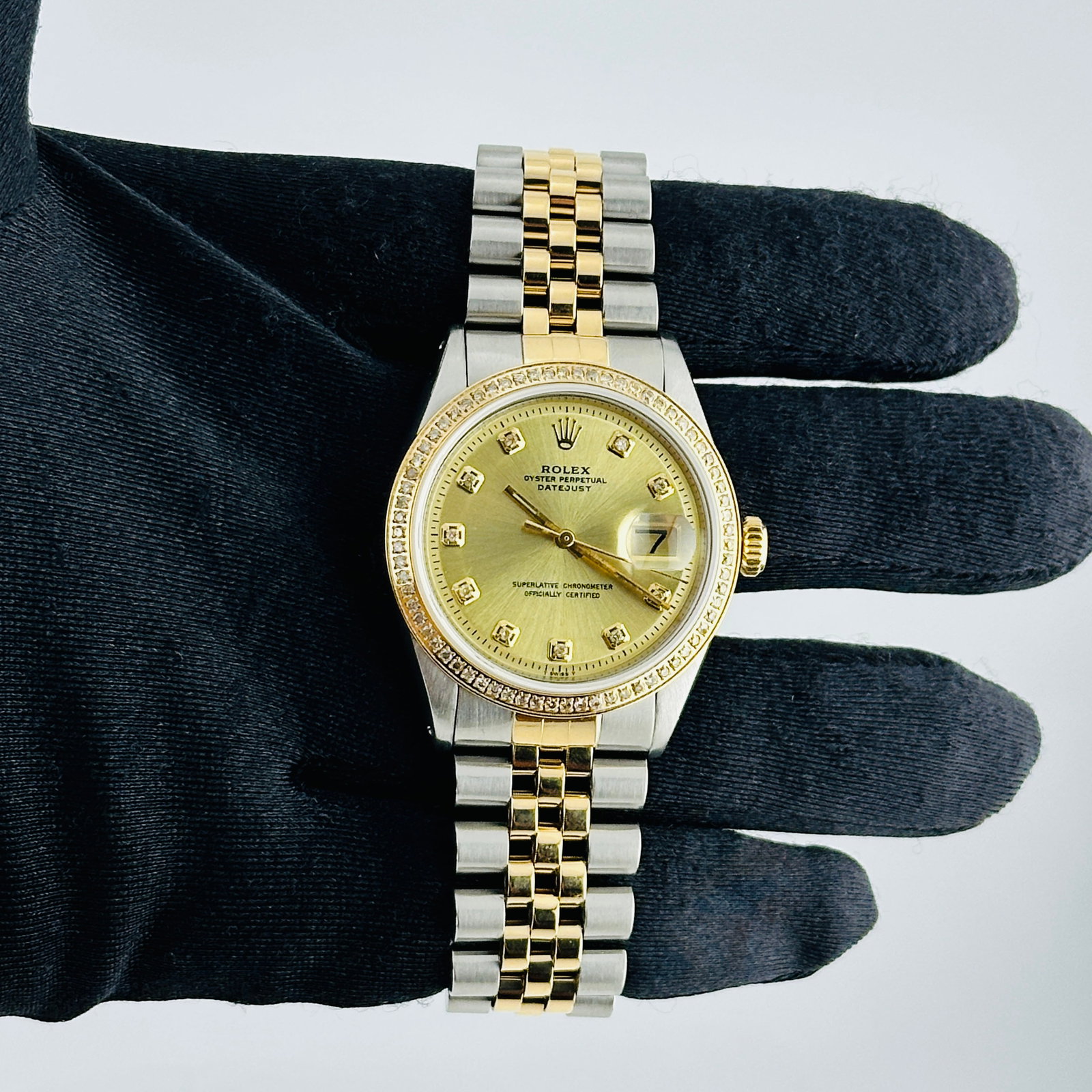 Rolex Aftermarket Diamond Champagne Dial D Link Jubilee Watch Ref 1601: Rolex Aftermarket Diamond Champagne Dial D Link Jubilee Watch Ref 1601 This Rolex Datejust features an Aftermarket champagne diamond dial, complemented by a pave plated diamond bezel. The watch is equ