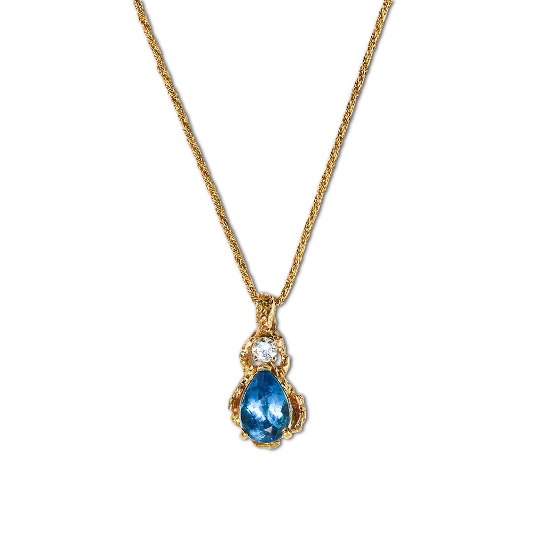 Pear Swiss Blue Topaz Pendant Necklace in 14K Yellow Gold with 0.33 ct Diamond: Pear Swiss Blue Topaz Pendant Necklace in 14K Yellow Gold with 0.33 ct Diamond Pre-owned 14k yellow gold necklace featuring a natural pear-shaped Swiss blue topaz pendant accented by an old Euro cut d