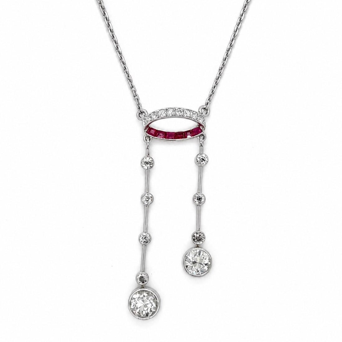 Platinum Art Deco Necklace with Diamonds and Rubies: Platinum Art Deco Necklace with Diamonds and Rubies This Art Deco necklace features a platinum setting adorned with two European-cut diamonds totaling approximately 2.50 carats (J-K color, VVS clarity