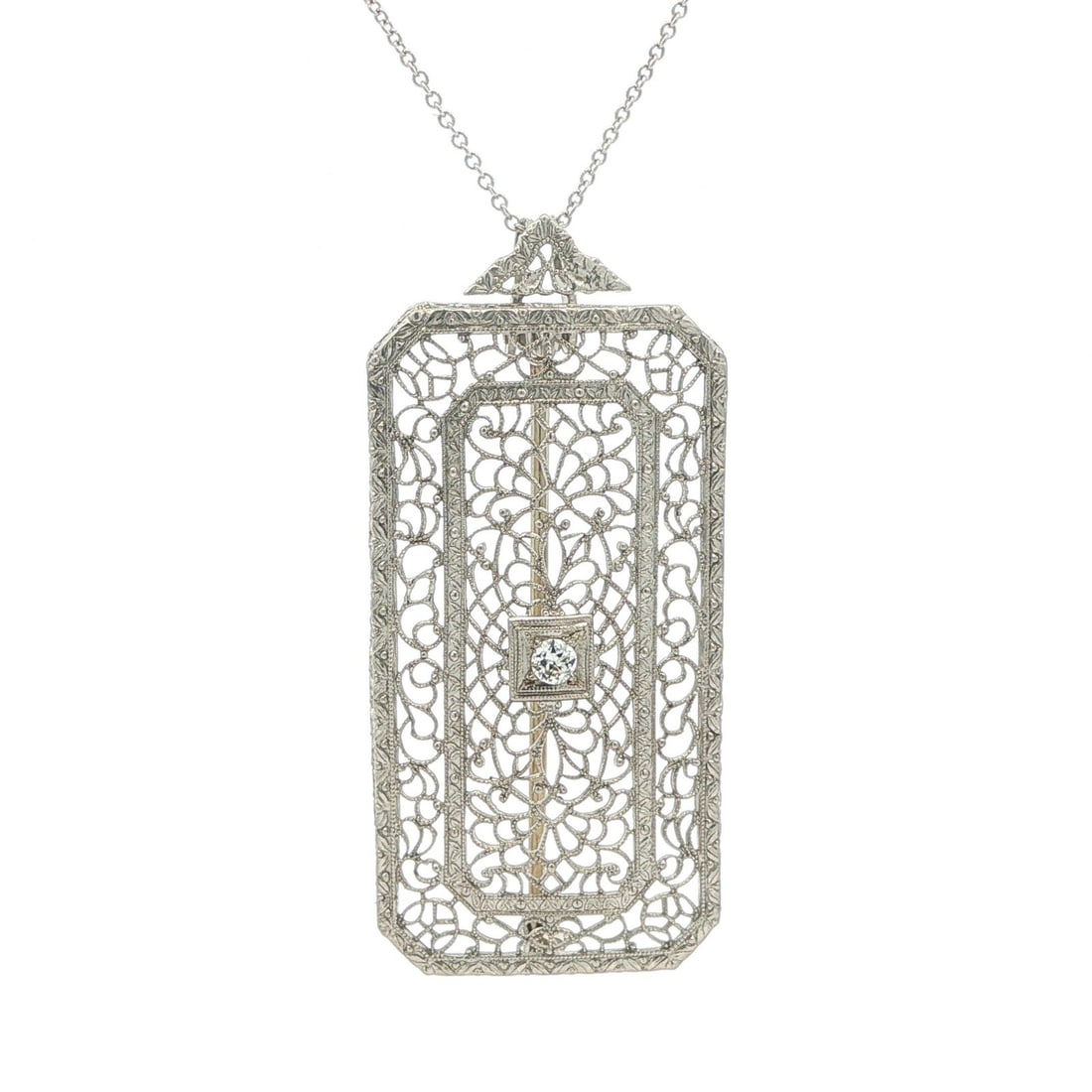 Art Deco filigree brooch pendant necklace in platinum and 14k white gold: Art Deco filigree brooch pendant necklace in platinum and 14k white gold Antique Art Deco brooch pin and pendant necklace featuring delicate filigree work and a natural old European cut diamond. This 
