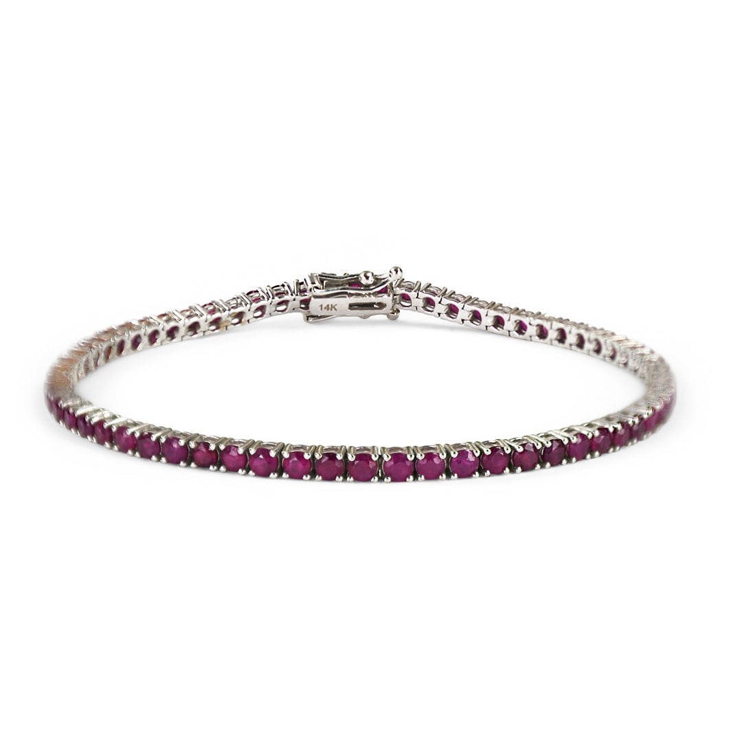 Natural Ruby Tennis Bracelet in 14K White Gold 7 Inch: Natural Ruby Tennis Bracelet in 14K White Gold 7 Inch Pre-owned ladies' 14k white gold tennis bracelet set with natural red rubies. This bracelet features round brilliant-cut rubies with a stated tota