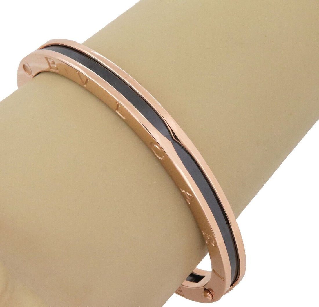 Bvlgari B.zero1 18k Rose Gold Black Ceramic Hinged Bangle Bracelet: Bvlgari B.zero1 18k Rose Gold Black Ceramic Hinged Bangle Bracelet Pre-owned hinged bangle bracelet from the B.zero1 collection, crafted in 18k rose gold and black ceramic. The oval design features en