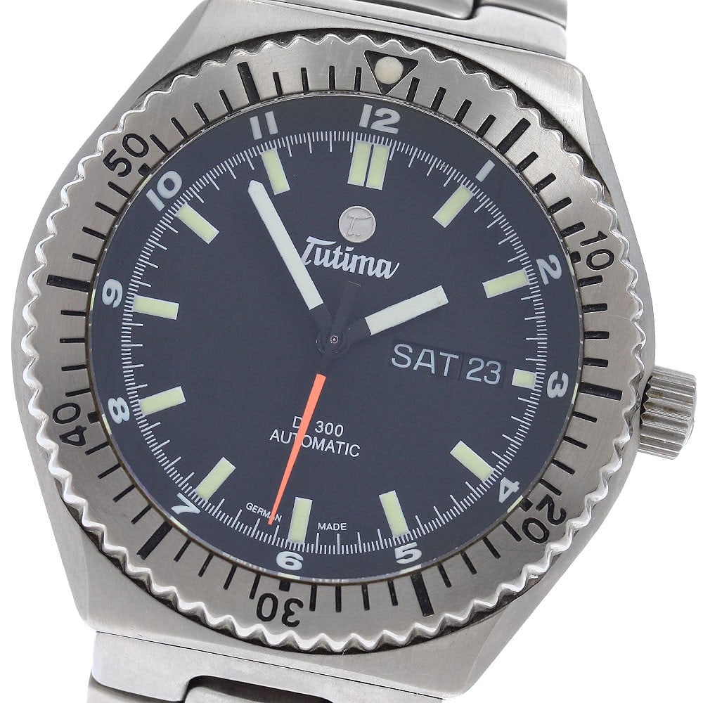 Tutima 629 DI300 Divers Automatic Titanium Day Date Mens Watch: Tutima 629 DI300 Divers Automatic Titanium Day Date Mens Watch Pre-owned Tutima DI300 Diver's Day-Date automatic men's wristwatch with a black dial and titanium case and bracelet. This watch-only offe