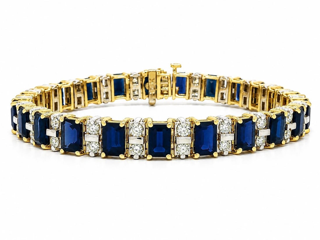 Emerald Cut Sapphire Diamond Tennis Bracelet 14k Two Tone Gold: Emerald Cut Sapphire Diamond Tennis Bracelet 14k Two Tone Gold This elegant tennis bracelet features 23 emerald-cut natural blue sapphires, each measuring approximately 6x4mm and prong set for secure 