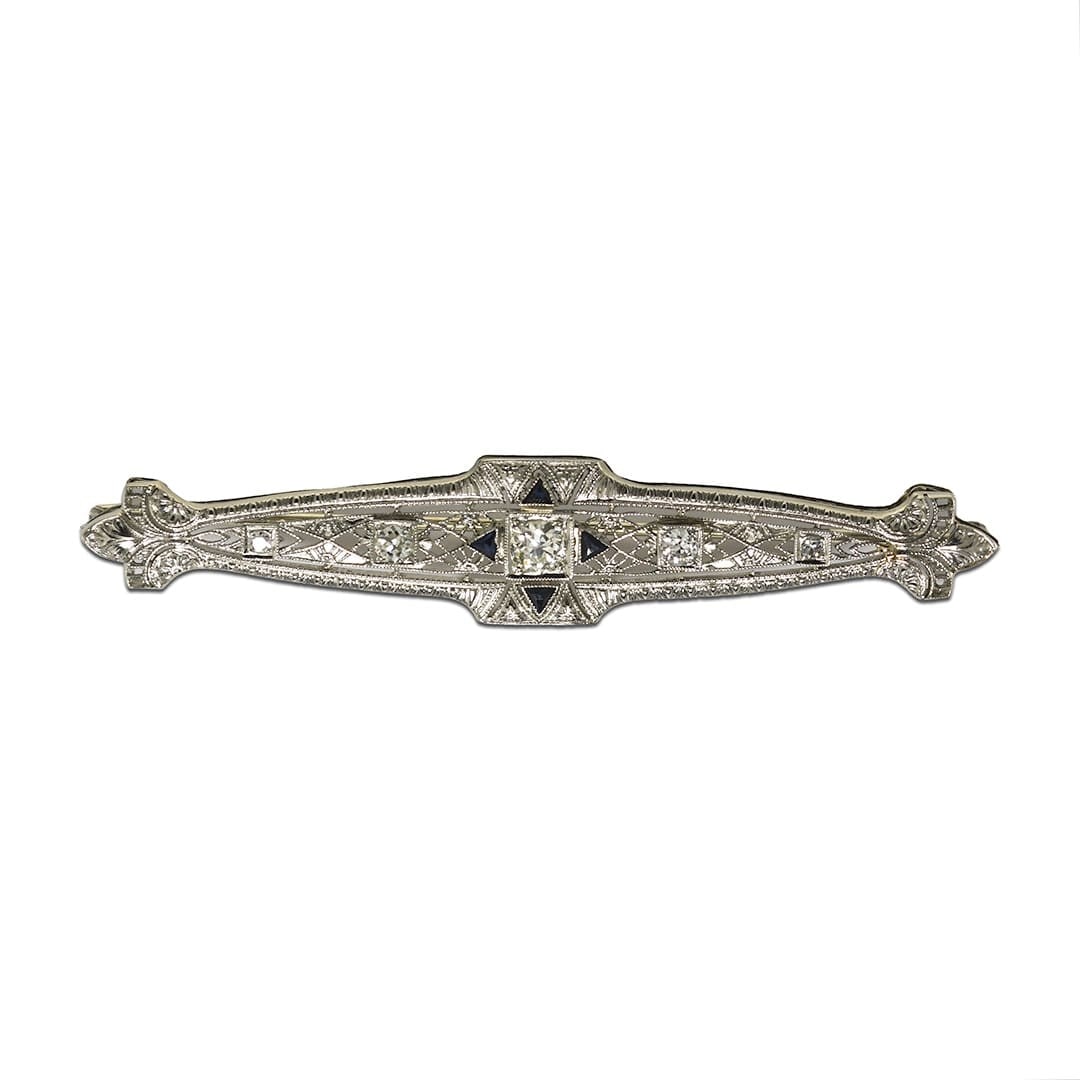 Antique 14K White Gold Diamond Art Deco Brooch: Antique 14K White Gold Diamond Art Deco Brooch This antique Art Deco brooch is crafted in 14k white gold and features a total of 0.50 carats of diamonds. The centerpiece is a 0.25 carat transition cut