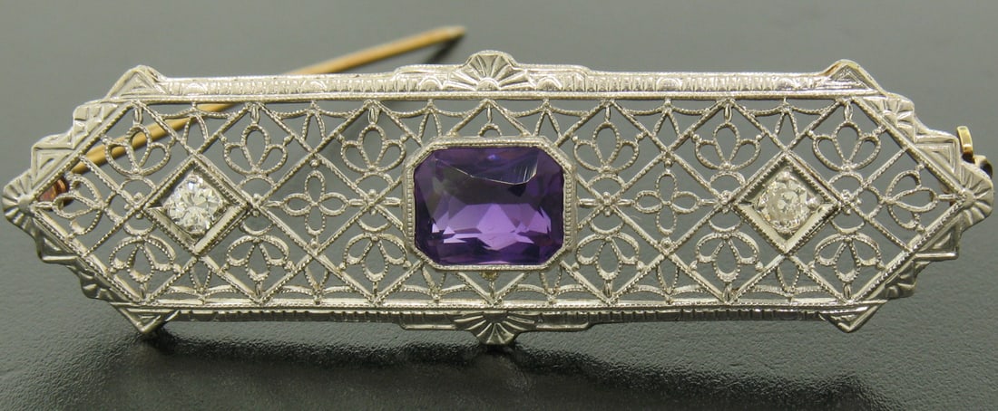 Art Deco filigree brooch 14k gold platinum amethyst and old cut diamonds: Art Deco filigree brooch 14k gold platinum amethyst and old cut diamonds Antique Art Deco brooch crafted in 14k solid yellow gold with an 850+ platinum top, featuring a natural genuine amethyst accent