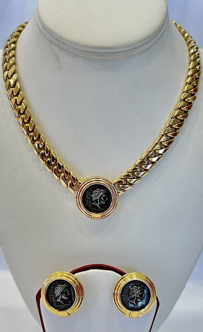 Italian yellow gold necklace and earrings set with coin motif: Italian yellow gold necklace and earrings set with coin motif A modern Italian yellow gold necklace and pair of earrings set with coin details and enamel accents. The necklace is made of 14k yellow go