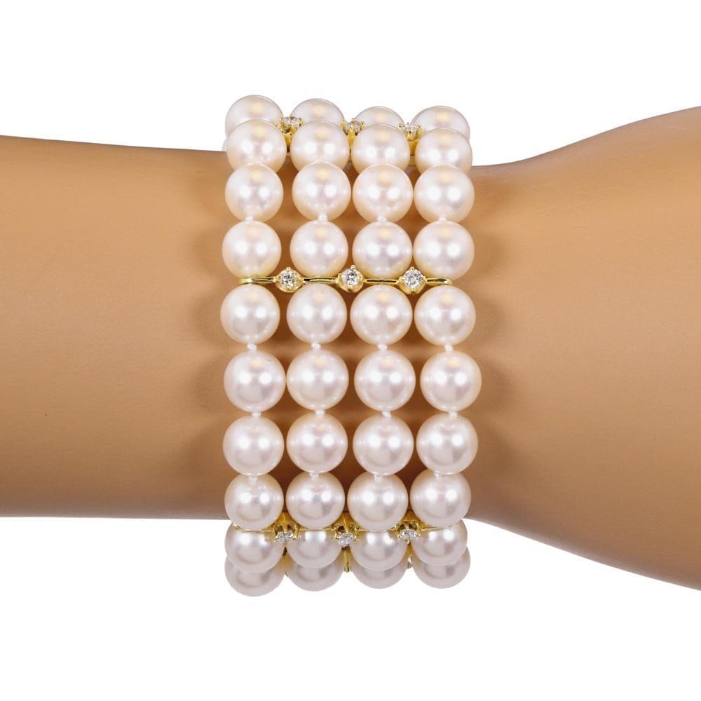 18k Yellow Gold Pearl Bracelet with Diamonds 1 Carat 4 Strand Design: 18k Yellow Gold Pearl Bracelet with Diamonds 1 Carat 4 Strand Design This exquisite bracelet showcases a stunning design featuring four strands of lustrous 7mm pearls in a delicate light pink tone, el
