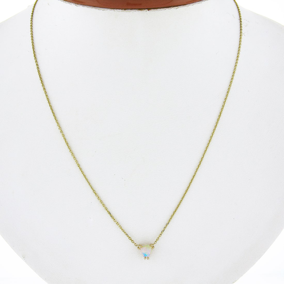 14k Yellow Gold Adjustable Opal Pendant Necklace with Cable Chain: 14k Yellow Gold Adjustable Opal Pendant Necklace with Cable Chain This exquisite pendant necklace features a stunning 14k yellow gold design showcasing a beautiful trillion cabochon cut opal. The pend