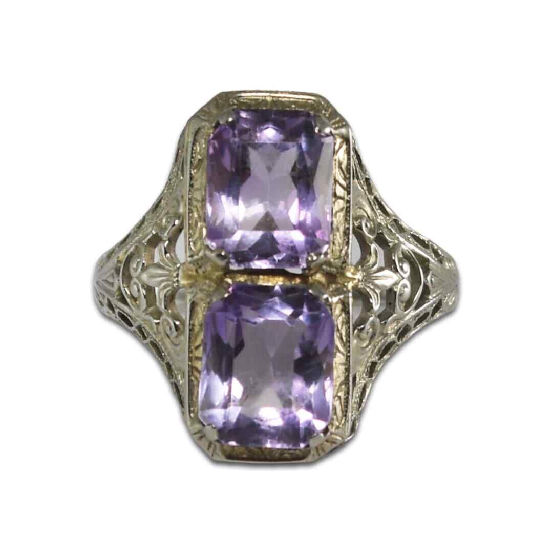 Art Deco 18K White Gold Two-Stone Amethyst Ring Size 8: Art Deco 18K White Gold Two-Stone Amethyst Ring Size 8 This Art Deco ring features two light purple amethyst stones set in 18k white gold. Each amethyst measures 8mm by 6mm and is accented by finely p
