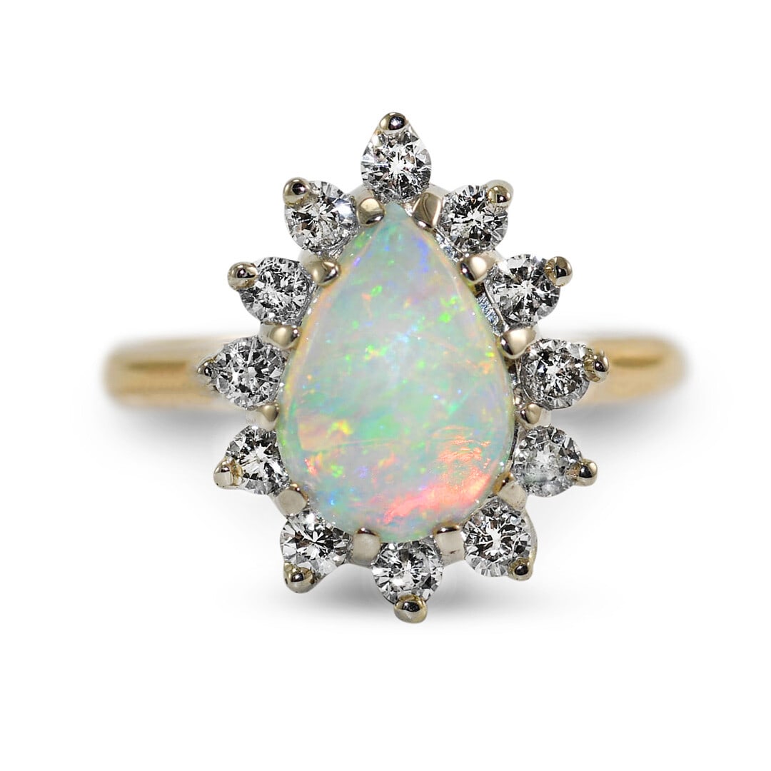 Vintage 14k Yellow Gold Australian Opal Diamond Ring: Vintage 14k Yellow Gold Australian Opal Diamond Ring This vintage ladies' ring features a natural pear-shaped Australian opal set in 14K yellow gold, accented by round brilliant cut diamonds. The opal